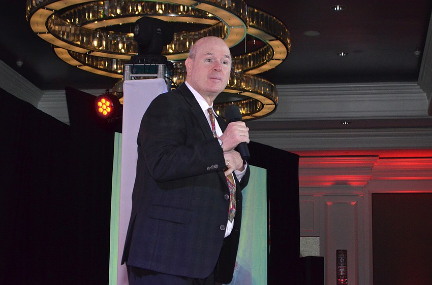 Comic Larry Miller performs for the crowd.