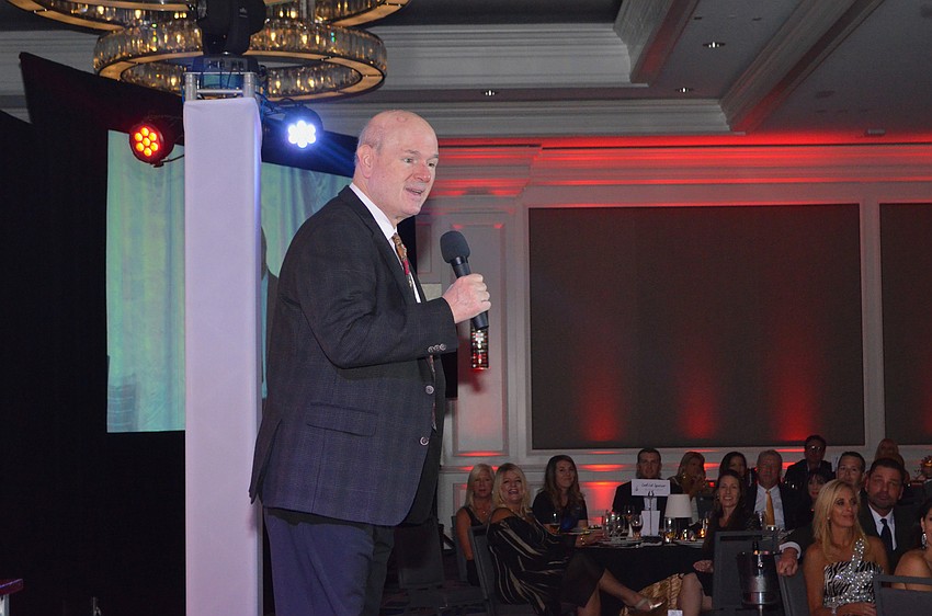 Comic Larry Miller performs for the crowd.