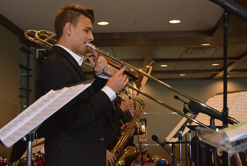 Ben Lafo, trombone player for the Sarasota Youth Orchestra, performs for attendees.