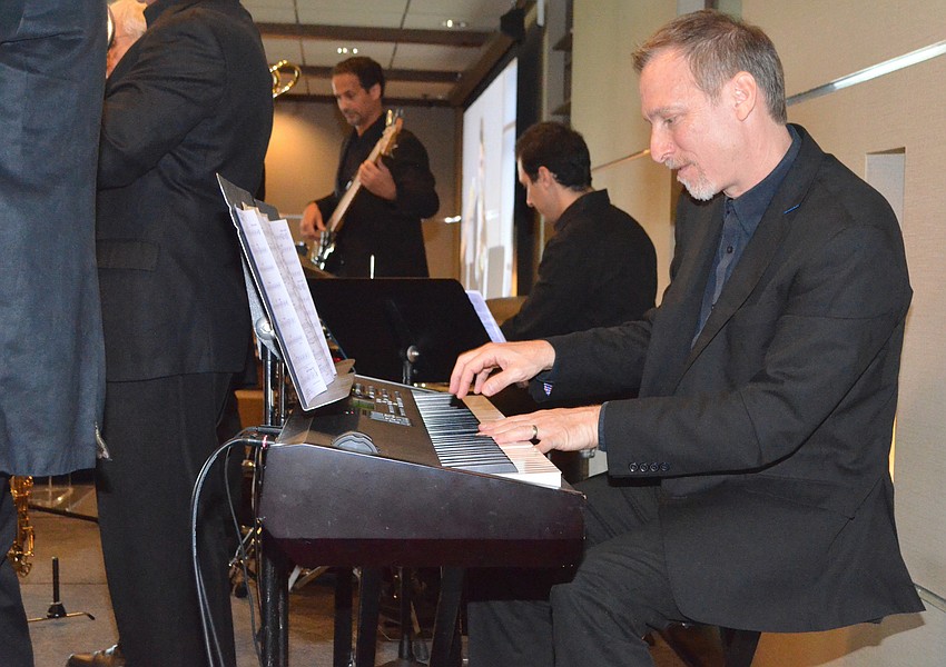 Anthony Mongillo, keyboard player for the Sarasota Jazz Ensemble, performs for attendees.