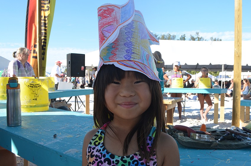 Chloe Light shows off the hat she made in the children's area earlier that day.
