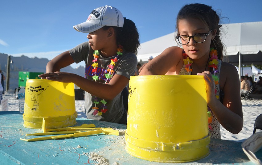 Charlie Merrill and Alyvia Logan try their hand at sand sculpting in the 
