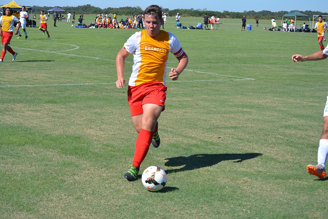 Lakewood Ranch Chargers U16 midfielder Liam Wahlstrom gets control of the ball.