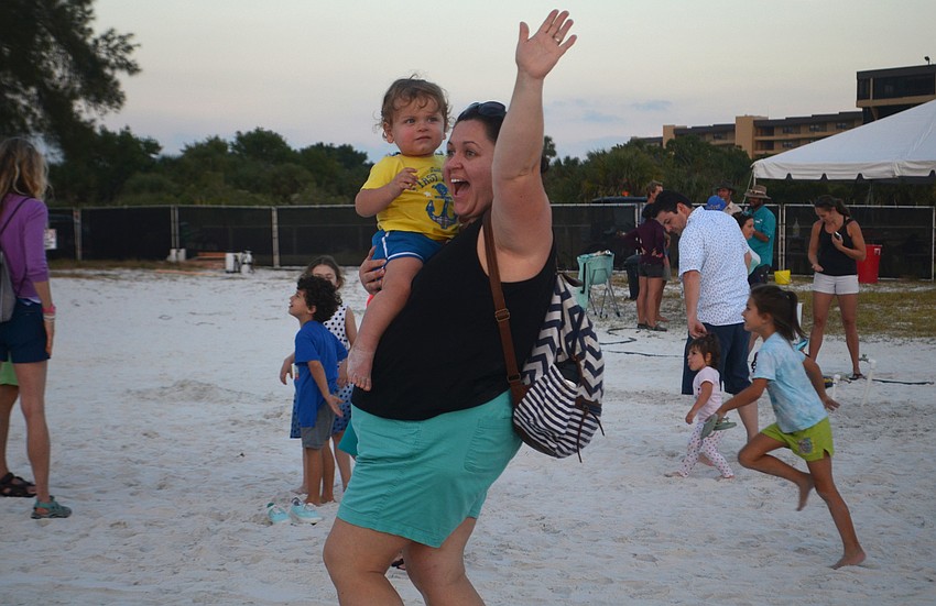 Jurgita Borrelli poses with her one-year-old son Lucas Borrelli for a photo behind one of the sculptures.