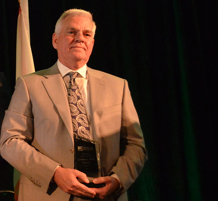 Community AIDS Network CEO Richard Carlisle accepts an award during the Greater Sarasota Chamber of Commerceâ€™s Salute to Business.