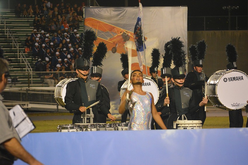 Senior Aidan Kelly performs with the color guard.