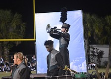 Ian Belloise plays the trumpet standing above Ted Robinson.