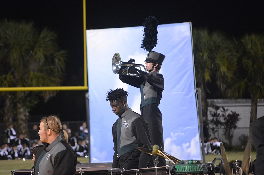 Ian Belloise plays the trumpet standing above Ted Robinson.