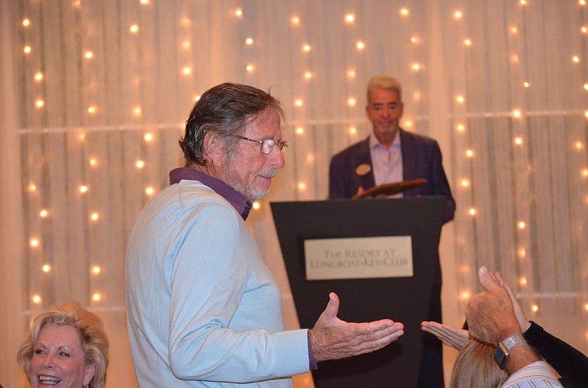 Larry Straff shakes hands with friends on his way to accept the Robert T. Ruff award on Nov. 14.