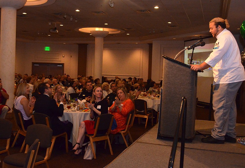 The crowd claps after Jesse Durant, a previous foster child, tells his success story of going from a domestic violence accusation to beginning culinary school at Manatee Technical College.