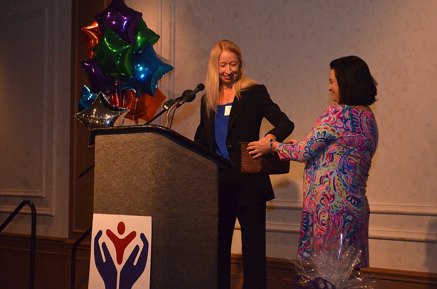 Wendy Cox, board member and Guardian ad Litem, picks the winning raffle ticket.