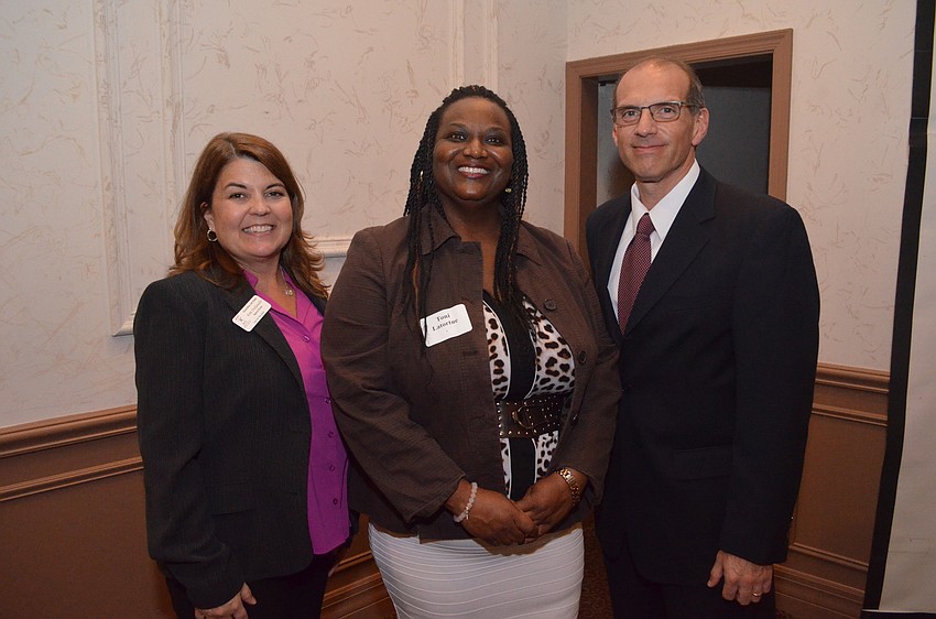 Kim DelGaudio, regional director of Florida Guardian Ad Litem Program, with Toni Latortue and Frank Prado