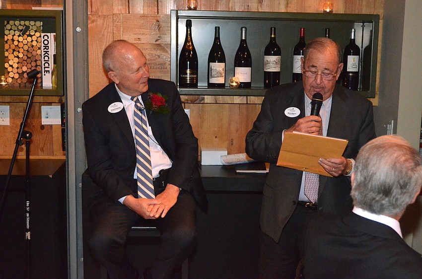 Scott Anderson listens to JHCF Board President Merrill Wynne recite a poem that he wrote for the roast. Wynne signed and laminated the poem so he would give it to Anderson as a gift.