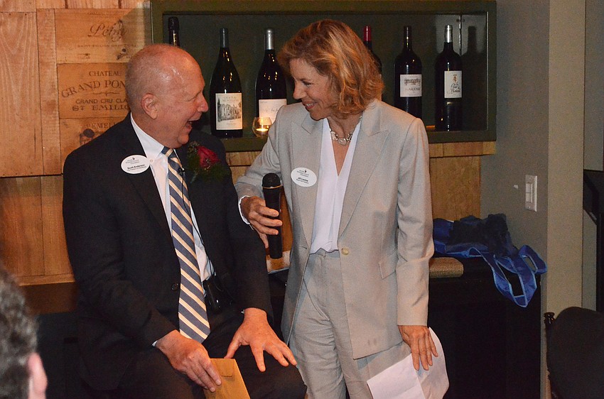 Scott Anderson laughs as Jill Levine roasts him.