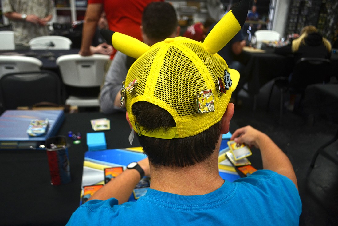 Alex Freeman wears a Pikachu hat during one of Dark Side Comic's Sunday Pokemon tournaments.