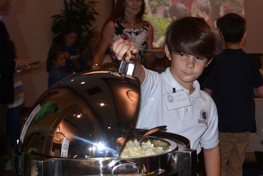 Southside third-grader Costa Arent serves roasted cauliflower mash to attendees of the event.
