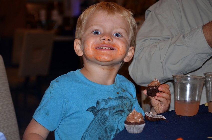 Colin Sellers poses with a chocolate cupcake during Southside's Farm to Fork dinner.