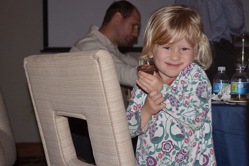 Raina Kurnov. 3, eats a chocolate cupcake.