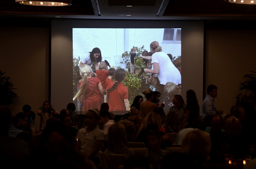A slideshow showing the students' work in the school's garden played while attendees enjoyed food cooked with ingredients the children grew.