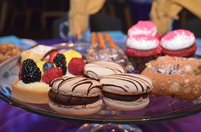 Guests munched on assorted desserts including fruit tarts, macarons, cannolis, cupcakes and chocolate-covered pretzels.