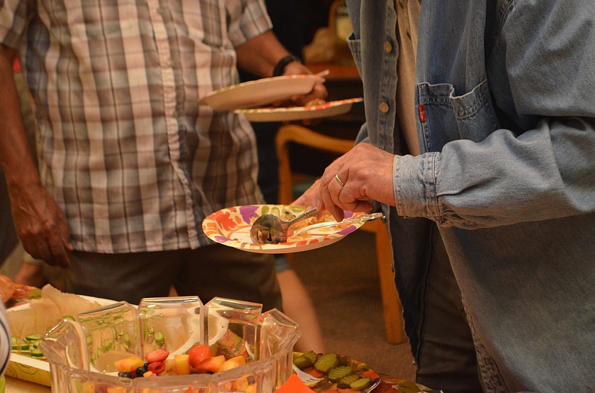 Guests pile fruit salad on their plates during Seaplace’s Welcome Back Dinner on Nov. 16.