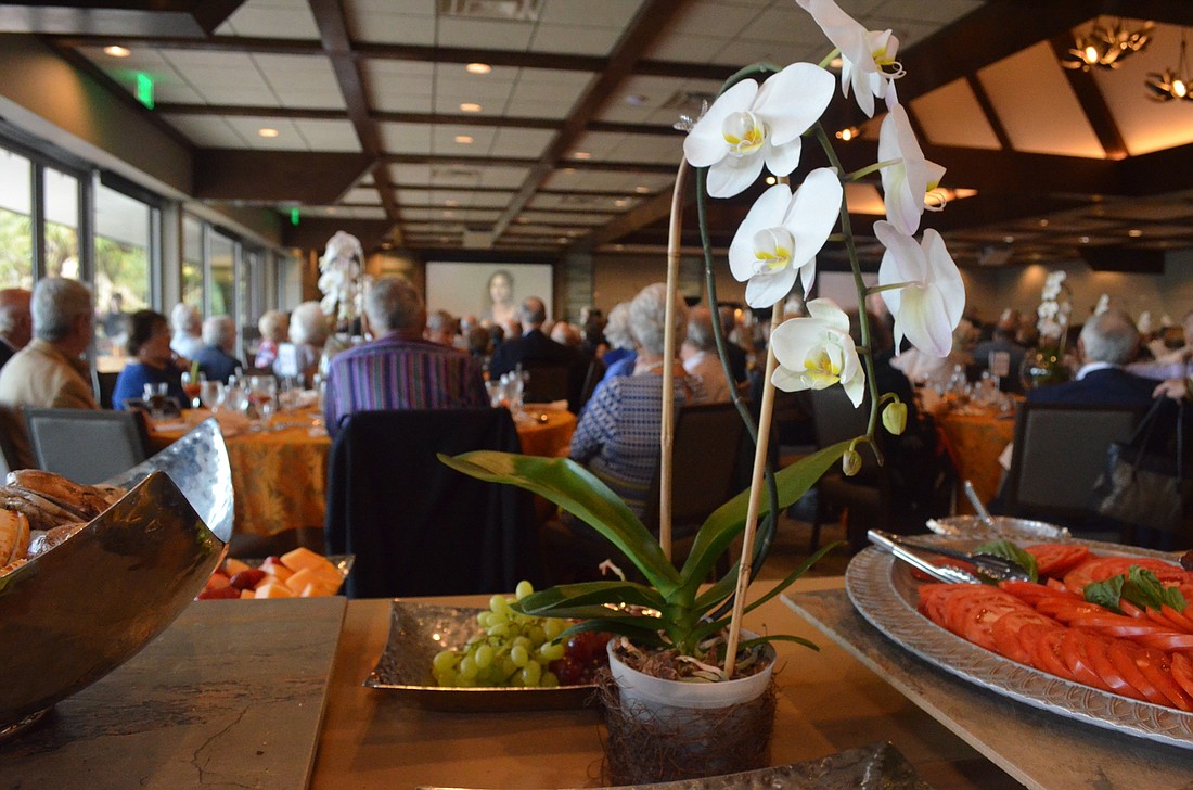 Every table at the Sarasota Orchestra's Side By Side Brunch was adorned with an elegant orchid centerpiece. Each orchid was then donated to local extended-care facilities. Photo by Niki Kottmann.