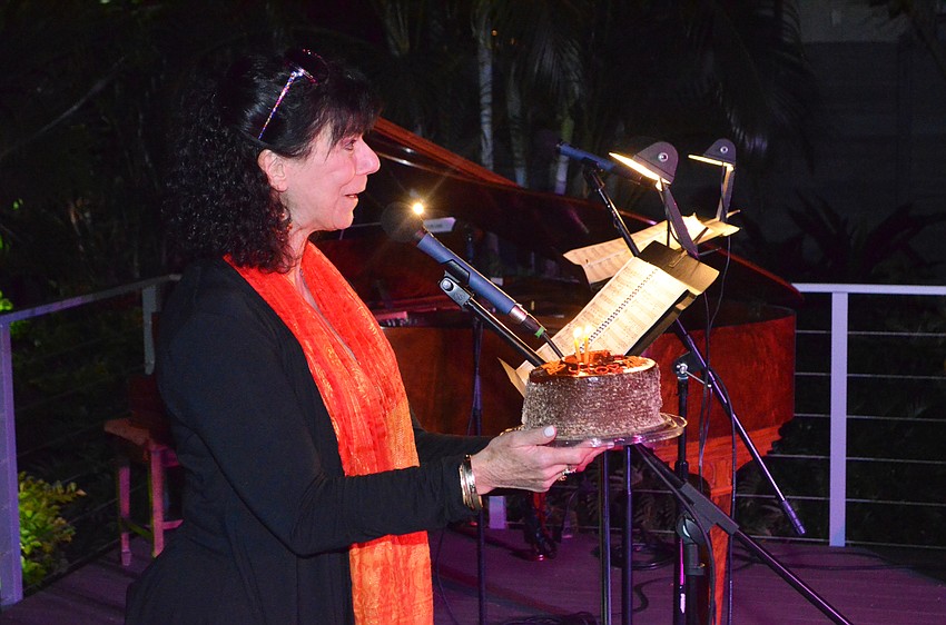 Co-Chairwoman Carolyn Michel sings happy birthday to Jim Buck.