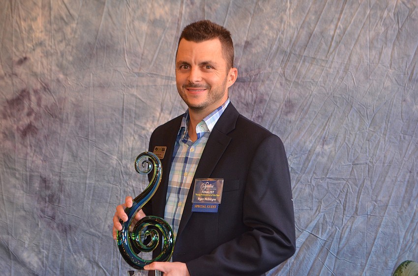 Ryan McIntyre, Elwell and Strammer General Contractors, holds his trophy after being named 