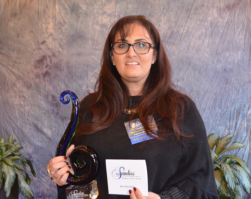Felicia Seedorf, Chapman & Associates Real Estate Appraisers, with her trophy after being named 