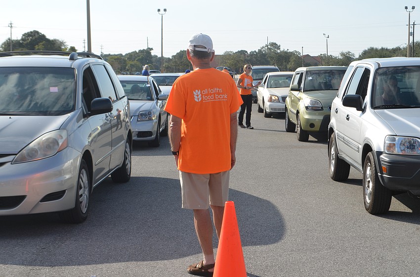 Tommy Bernstein helps manage the lines during the All Faiths Food Bank annual turkey giveaway.