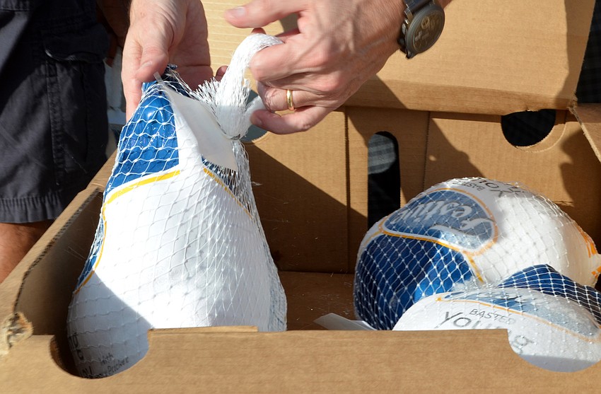 About 50 volunteers helped pass out turkeys, and direct traffic, but passing out the turkeys was the coveted task.
