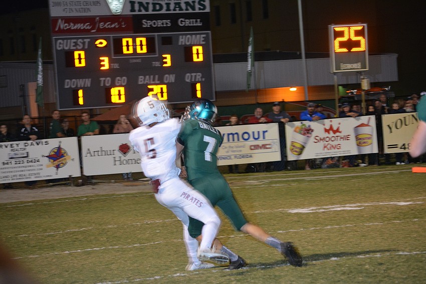 Braden River junior Tyrone Collins hangs on to a catch despite taking a hit.