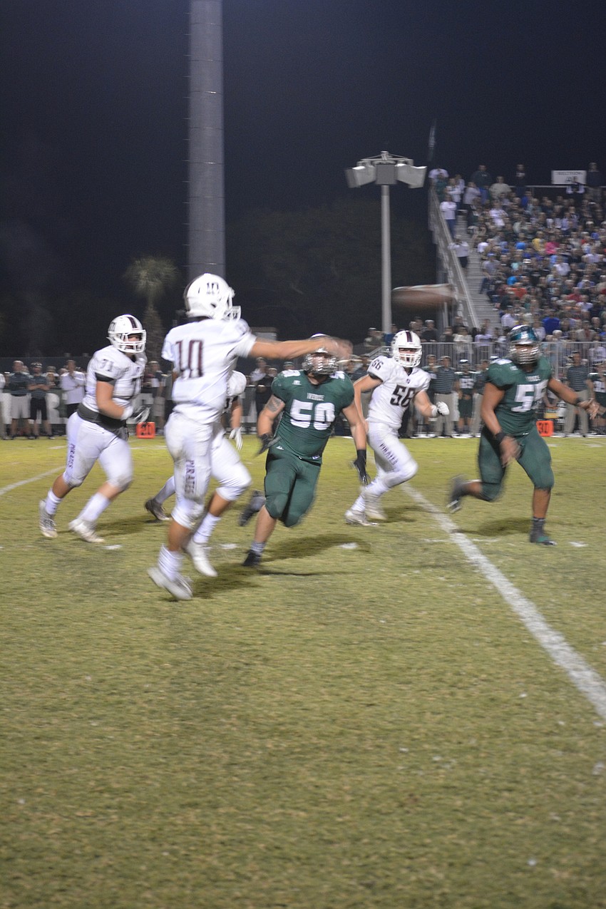 Braden River quarterback Louis Colosimo slings a pass downfield.