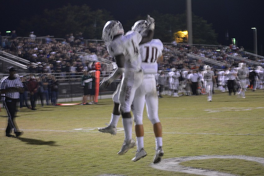 Braden River seniors Raymond Thomas and Louis Colosimo celebrate a Thomas touchdown.