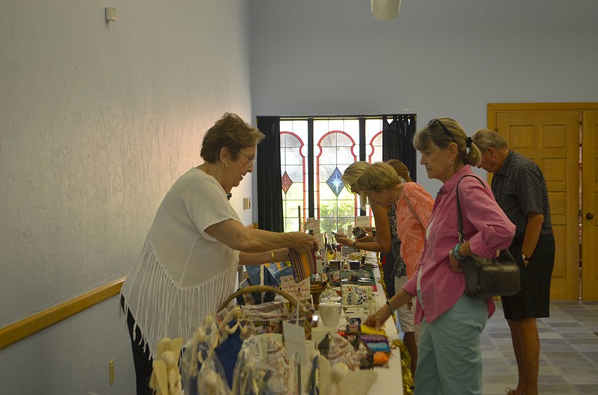 Mary Elizabeth Carey helps customers at the St. Mary Christmas Bazaar on Nov. 19.