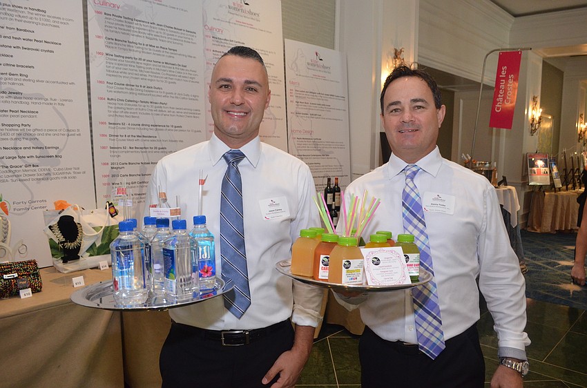 Solemen Jason Carney and Danny Foster serve water and pressed juice.