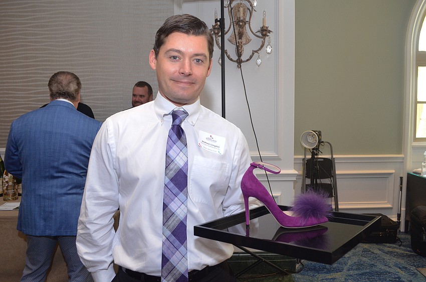 Soleman Matthew Livingston shows off one of the shoes available for purchase at the Saks Fifth Avenue vendor area.
