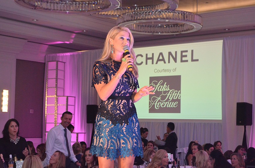 Emily Stroud, past Wine Women & Shoes Chairwoman, acts as the first guest auctioneer of the afternoon.