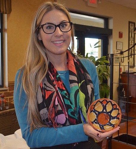Stephanie Grepling, the marketing and communications manager at Meals on Wheels Plus of Manatee, holds one of the ceramic bowls that were made for the upcoming Empty Bowls.