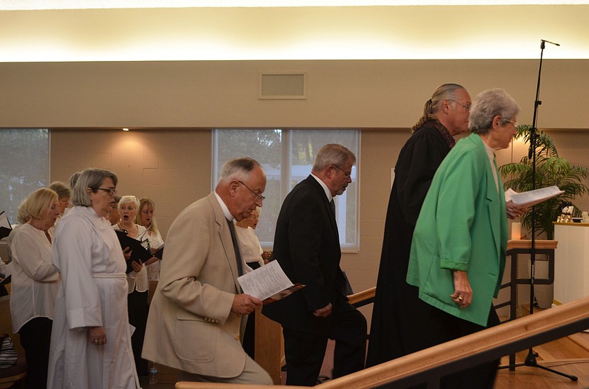 The clergy approach the altar during the processional hymn, “We Gather Together.”