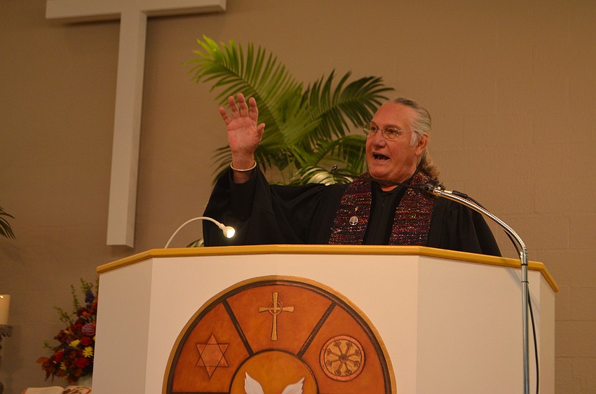 Rev. Bill Friederich, interim minister of the Longboat Island Chapel, greets the crowd at this year’s Thanksgiving Interfaith Service.