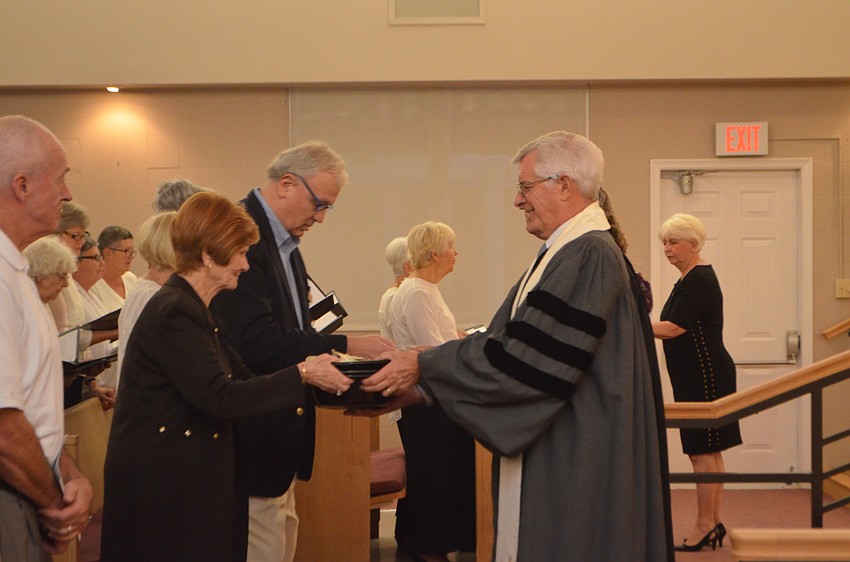 Rev. Norman Pritchard of Christ Church accepts the offering during the Thanksgiving Interfaith Service on Nov. 22.