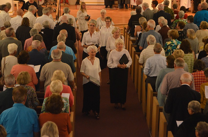 The interfaith choir sings “America the Beautiful” as the recessional hymn.