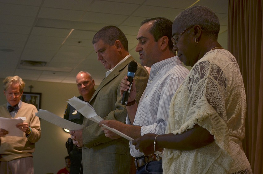 Superintendent Todd Bowden and former County Commissioner Caralyn Mason follow along as County Commissioner Caragiulo reads a portion of President Abraham Lincoln’s address, which made Thanksgiving a national holiday.