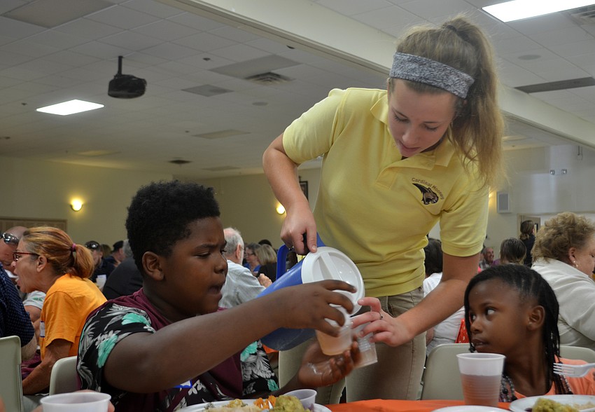 Cardinal Mooney High School Ava Wittmer serves Jazyren Jones at the luncheon.