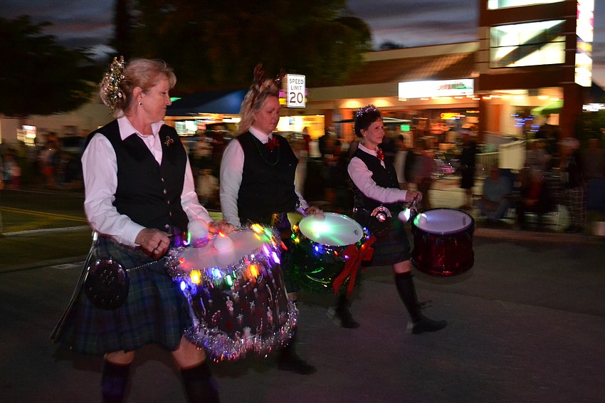 Members of the Blue Skye Pipes and Drums performing along the parade route.