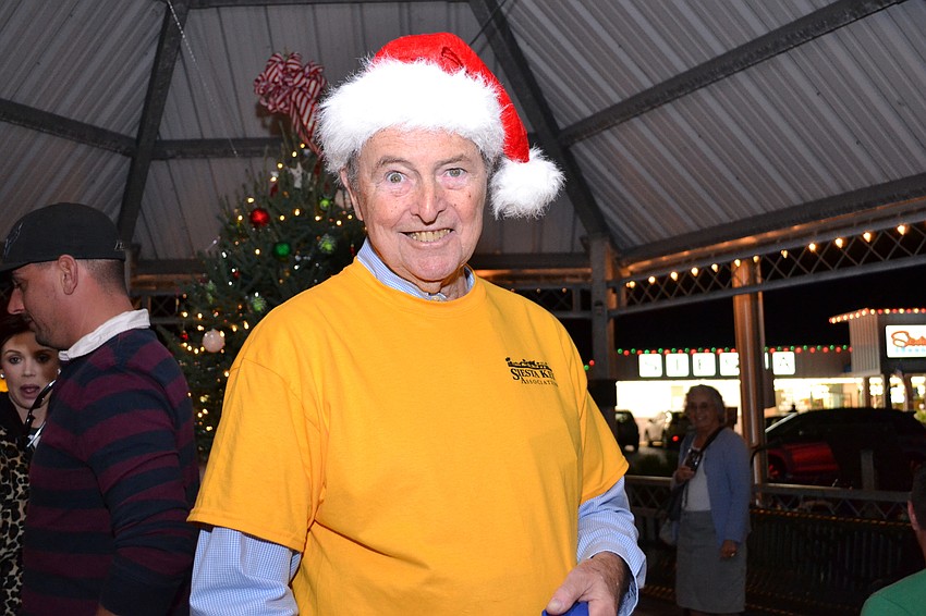 Don Lundy with Siesta Key Association hands out candy canes and holiday cheer in the gazebo.