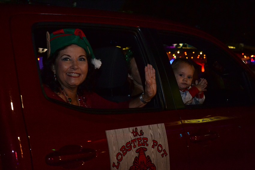 Kathy and Phoenix Medeiros wave to residents from the parade route.