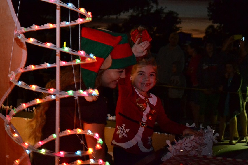 Olivia Derocher and Mikayla Medeiros wave from the float for Lobster Pot.