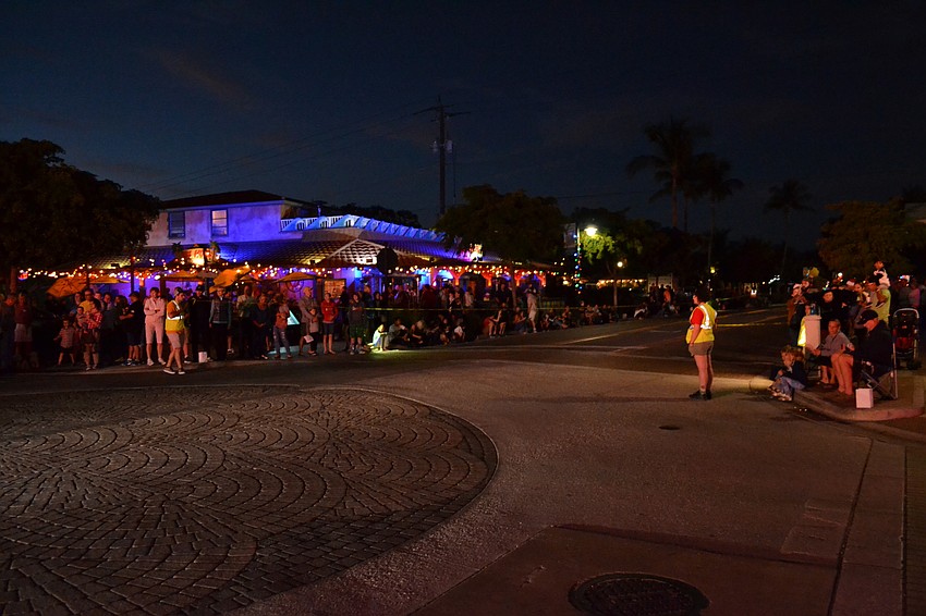 Residents fill in on the curb at the start of the Light Up The Village parade on Siesta Key Saturday, Nov. 26.